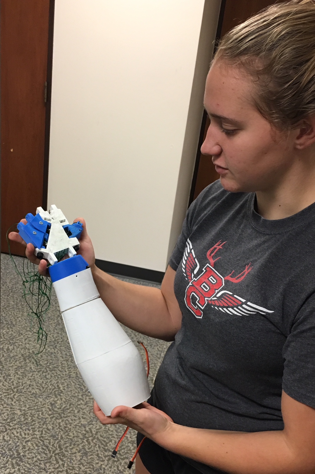 College-NOW student building prosthetic arm for coach
